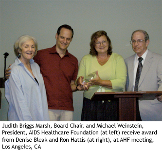 Judith Briggs Marsh, Board Chair, and Michael Weinstein, President, AIDS Healthcare Foundation (at left) receive award from Denise Bleak and Ron Hattis (at right), at AHF meeting, Los Angeles, CA 
