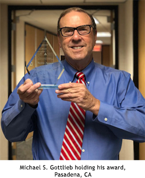 Michael S. Gottlieb holding his award.